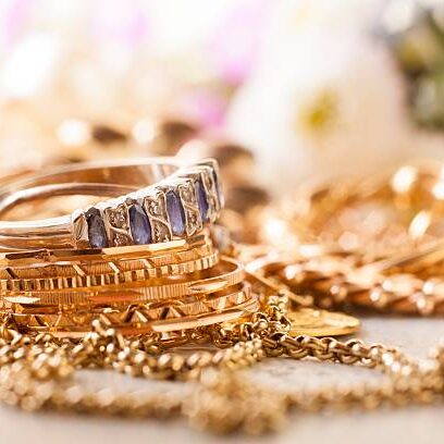 shiny gold and silver jewelery on white table