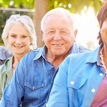 Outdoor Group Portrait Of Senior Friends Smiling To Camera